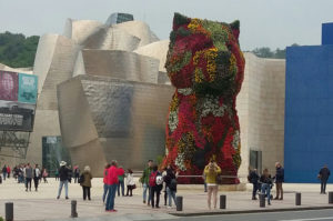 Entrance to the Guggenheim Museum in Bilbao Spain. "Puppy" flower sculpture by Jeff Koons (1992).