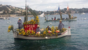 The Villefranche-sur-mer Naval Flower Battle features up to 20 local fishing boats decked out in elaborate flower arrangements