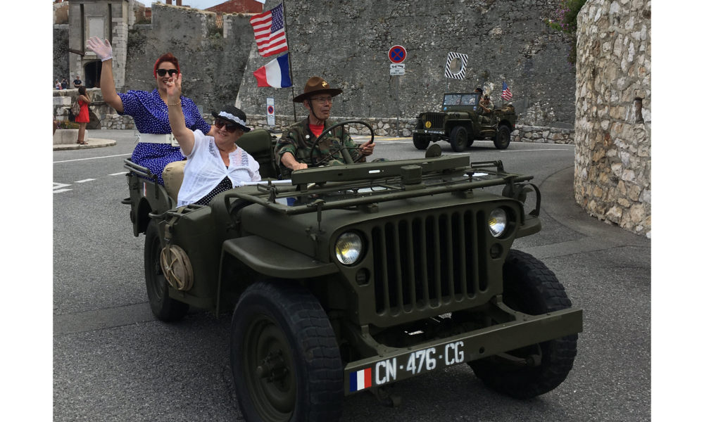 American jeeps with pin-up girls parading through the streets of Villefranche-sur-mer. July 4, 2018