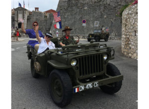 American jeeps with pin-up girls parading through the streets of Villefranche-sur-mer. July 4, 2018